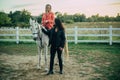 Happy young couple spending time together with their horses. People in love riding a horse. Royalty Free Stock Photo