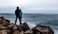 Happy Young Couple Standing Against A Stone Beach And Enjoy View Royalty Free Stock Photo