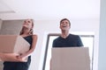 Happy young couple standing on the doorstep of their new apartment Royalty Free Stock Photo