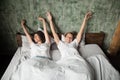 Happy young couple stretching in bed after wake up Royalty Free Stock Photo