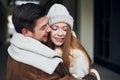 Happy young couple in stylish warm coats hugging on city street Royalty Free Stock Photo