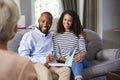 Happy young couple taking financial advice at home Royalty Free Stock Photo