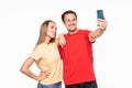 Happy young couple taking a selfie on white background Royalty Free Stock Photo