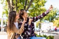 Happy young couple taking selfie photo with a smart phone at sunset on the beach Royalty Free Stock Photo