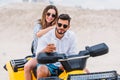 happy young couple taking selfie while sitting on ATV Royalty Free Stock Photo