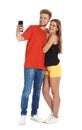 Happy young couple taking selfie on white Royalty Free Stock Photo