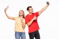 Happy young couple taking a selfie on white background Royalty Free Stock Photo