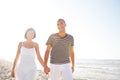 Happy young couple taking a walk on the beach.