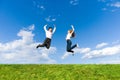 Happy Young Couple - team is jumping in the sky Royalty Free Stock Photo