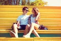 Happy young couple teenagers are sitting on the bench city Royalty Free Stock Photo