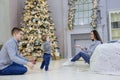 Happy young couple and their baby son near Christmas tree at home Royalty Free Stock Photo