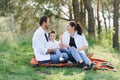 Happy young couple with their children have fun at beautiful park outdoor in nature Royalty Free Stock Photo