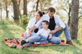 Happy young couple with their children have fun at beautiful park outdoor in nature Royalty Free Stock Photo
