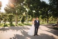 Happy young couple in their wedding day spend time in park. Green background Royalty Free Stock Photo