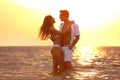 Happy young couple  time together on sea beach at sunset Royalty Free Stock Photo