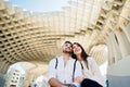 Happy young couple tourists visiting Setas de Seville aka Metropol Parasol, site seeing attractions.Vacation in south of Spain,