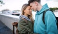 Happy young couple travelers in love in city on holiday, hugging.