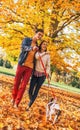 Happy young couple with two cute dogs walking in park Royalty Free Stock Photo