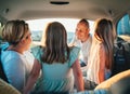 Happy young couple with two daughters inside the car trunk during auto trop. They are smiling, laughing and chatting. Portrait of Royalty Free Stock Photo