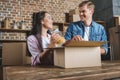 happy young couple unpacking boxes on kitchen while moving into Royalty Free Stock Photo