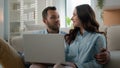 Happy young couple using laptop for ecommerce doing online shopping with shop app together at home Caucasian man and Royalty Free Stock Photo