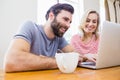 Happy young couple using laptop Royalty Free Stock Photo