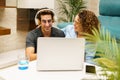 Happy young couple using laptop at home Royalty Free Stock Photo