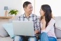 Happy young couple using laptop Royalty Free Stock Photo