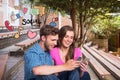 Happy young couple using social media on mobile phones by icons Royalty Free Stock Photo