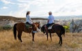 happy young couple on vacation Turkey Kapadokya horse riding in the mountains of Cappadocia Goreme Royalty Free Stock Photo