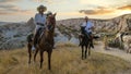 happy young couple on vacation Turkey Kapadokya horse riding in the mountains of Cappadocia Goreme Royalty Free Stock Photo