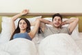 Happy young couple waking up in the morning on bed Royalty Free Stock Photo