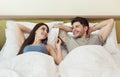 Happy young couple waking up in the morning on bed Royalty Free Stock Photo