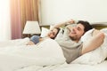 Happy young couple waking up in the morning on bed Royalty Free Stock Photo