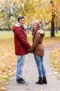 Happy young couple walking in autumn park Royalty Free Stock Photo