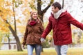 Happy young couple walking in autumn park Royalty Free Stock Photo