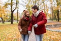 Happy young couple walking in autumn park Royalty Free Stock Photo