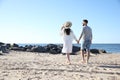 Happy couple walking on beach near sea. Honeymoon trip Royalty Free Stock Photo