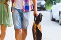 Happy young couple walking with guitar drinking juice spending c Royalty Free Stock Photo