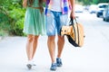 Happy young couple walking with guitar drinking juice spending c Royalty Free Stock Photo