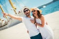 Happy young couple walking by the harbor of a touristic sea resort Royalty Free Stock Photo