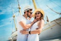 Happy young couple walking by the harbor of a touristic sea resort Royalty Free Stock Photo