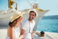 Happy young couple walking by the harbor of a touristic sea resort Royalty Free Stock Photo