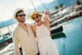 Happy young couple walking by the harbor of a touristic sea resort Royalty Free Stock Photo