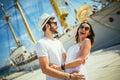 Happy young couple walking by the harbor of a touristic sea resort Royalty Free Stock Photo