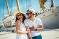 Happy young couple walking by the harbor of a touristic sea resort Royalty Free Stock Photo