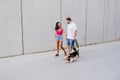 Happy young couple walking outdoors with beagle dog. Family and lifestyle concept Royalty Free Stock Photo