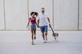 Happy young couple walking outdoors with beagle dog. Family and lifestyle concept Royalty Free Stock Photo
