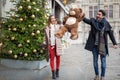 Happy young couple walking on a street at chrstmas time holding