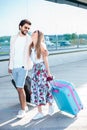 Young couple walking in front of an airport terminal building Royalty Free Stock Photo